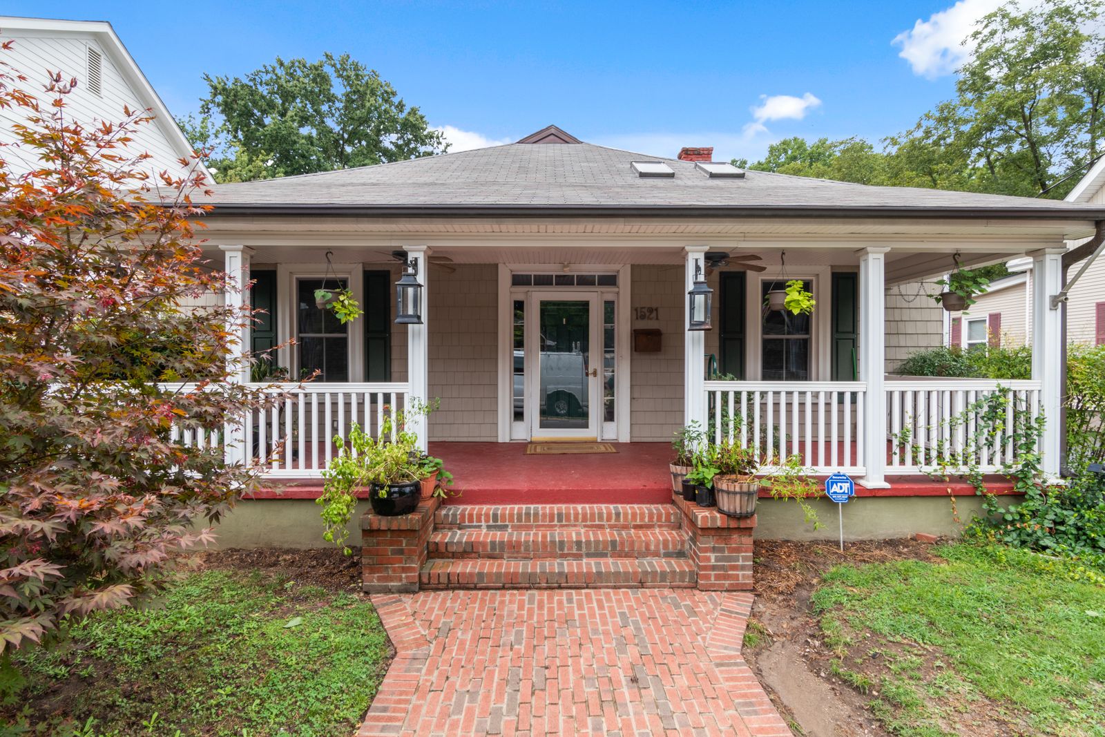 Bungalow with a covered front porch and brick walkway